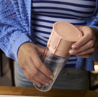 Person holding BRITA water filter bottle Model Vital in apricot